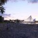 large building near beach lit up at dusk