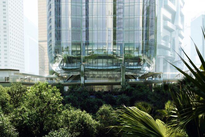 The base of the skyscraper, surrounded by greenery.