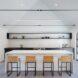 yellow bar stools at a white kitchen island