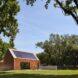 wood gabled building with solar panels