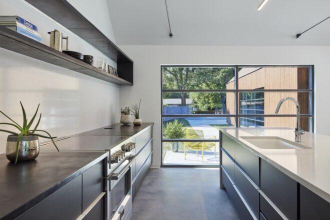 kitchen with black cabinetry and a wall of glass