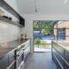 kitchen with black cabinetry and a wall of glass