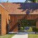 gabled wood building with black metal-framed windows