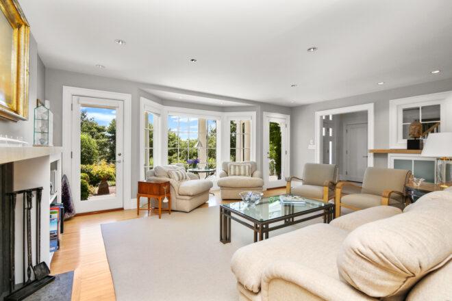 living room with gray walls, white furnishings and large windows