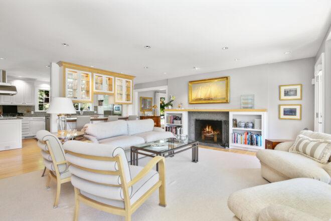 white furnishings facing a fireplace