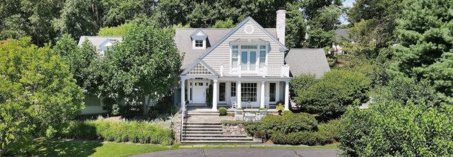 large white home with gabled room and large front porch