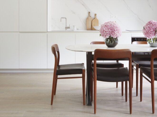 white dining table with dark wood chairs