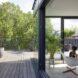 living room with sliding glass open to wooden deck