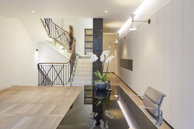 black reception desk near large staircase