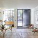 apartment with white walls, large black front door, and minimalist furniture