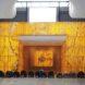 people kneeling in front of yellow prayer space in a mosque
