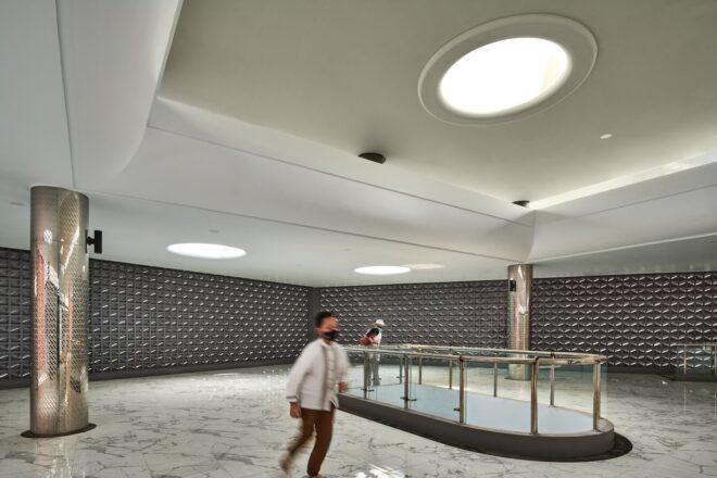 mosque interior with gray walls, marble floors and a skylight