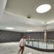 mosque interior with gray walls, marble floors and a skylight