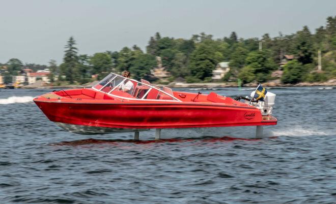 person driving red speedboat