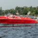 person driving red speedboat