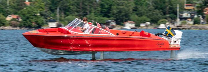 red electric speedboat with hydrofoils on water