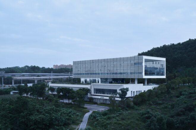 aluminum and white building surrounded by forest