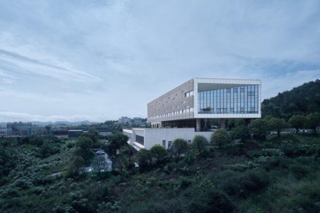 aluminum building elevated above white building