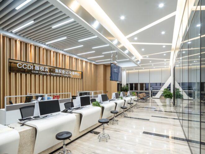 office with several desks near wood wall