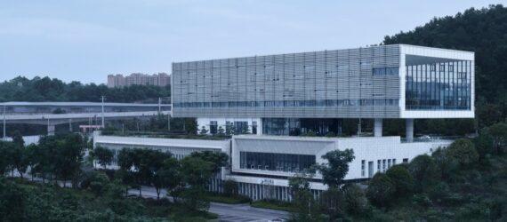 aluminum and white building surrounded by forest