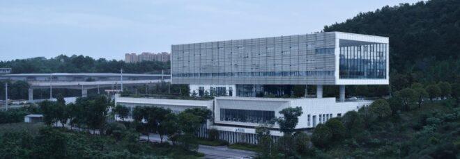 aluminum and white building surrounded by forest
