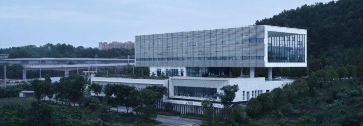 aluminum and white building surrounded by forest