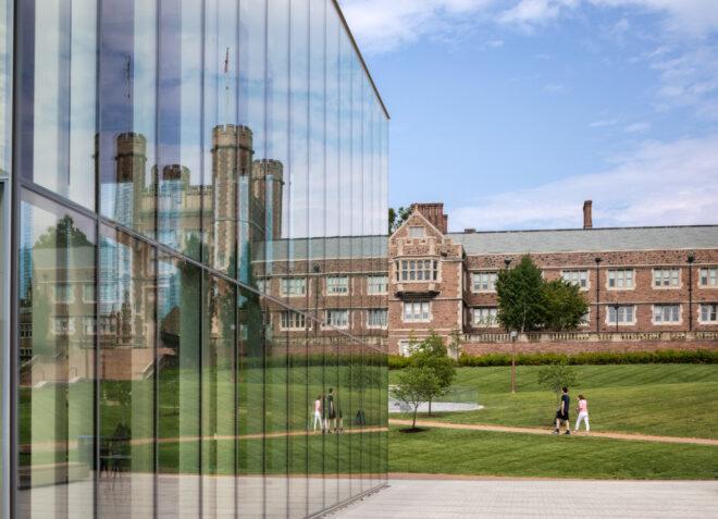 glass building facing traditional brick university building