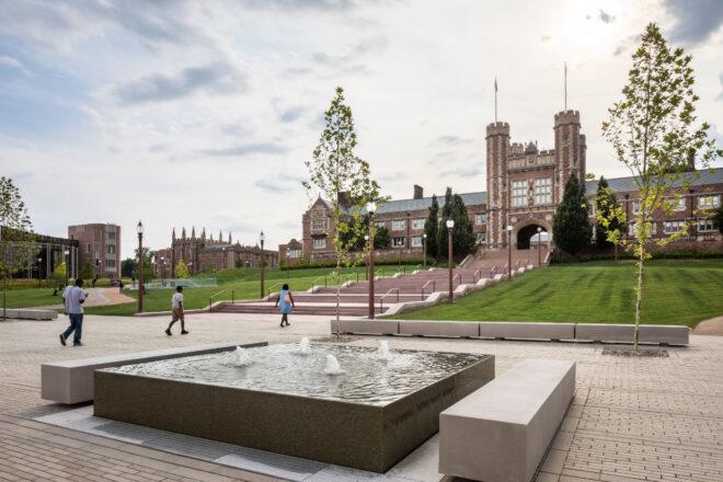 square fountain outside brick building
