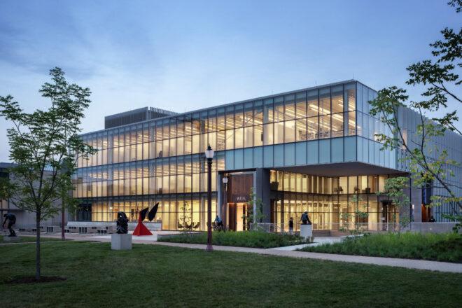 grassy lot in front of glass building