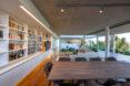 wood dining table near wall of bookshelves