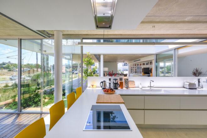 yellow stools against a white kitchen peninsula