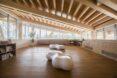white, bubble-like seats inside timber-lined building