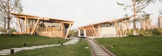 train traveling between two timber buildings