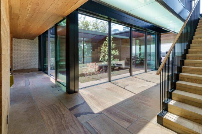 glass home with tree in central atrium