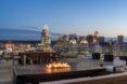 lounge chairs and firepit on rooftop deck at dusk