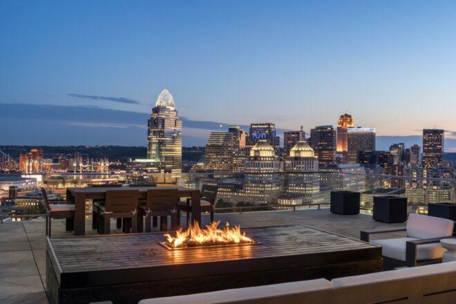 lounge chairs and firepit on rooftop deck at dusk