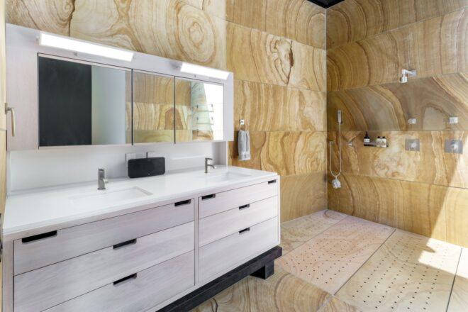 bathroom with wood walls and white vanity