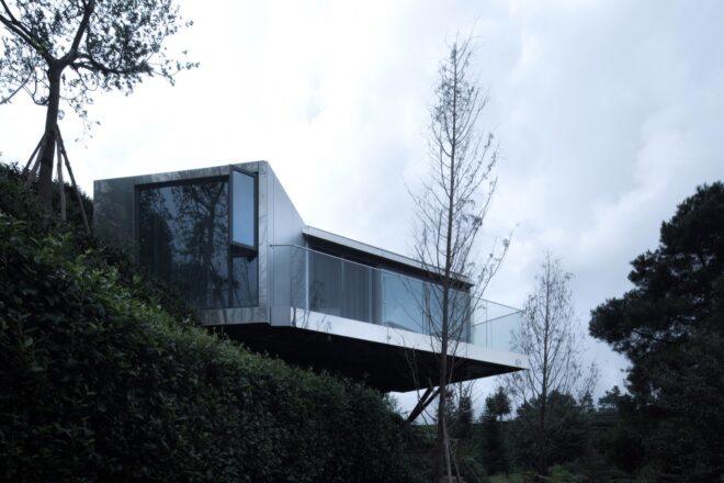 mirrored cabin perched on a hill