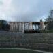 glass cabin with wood slat exterior near tea fields