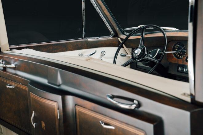 dark wood and cream leather interiors of a Rolls-Royce