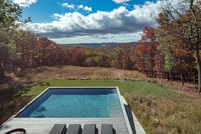 a backyard with a pool that looks out over the Hudson Valley.