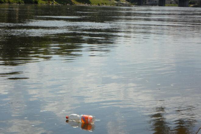 plastic bottle floating down a river