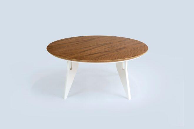 a round, wood-top table with white legs