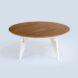 a round, wood-top table with white legs