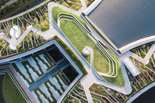 a multilevel green roof structure comprised of various geometric shapes and white walkways.