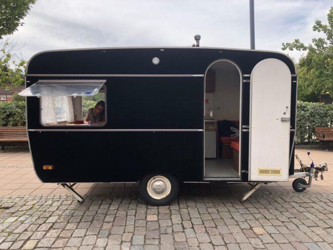 person working inside small travel trailer