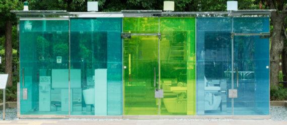public toilet building with blue and green glass walls