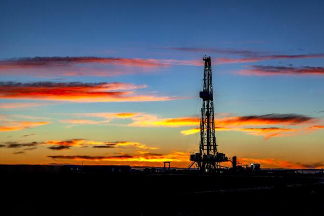 oil rig drilling at sunset