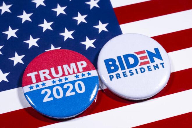 Biden for President button and Trump 2020 button on American flag background