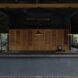 large outdoor kitchen with black counters and natural wood pantry doors